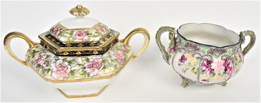 Nippon Moriage Cube Sugar Bowl and Covered Sauce Tureen: Moriage handled bowl is 4 1/4" tall, has 1/2" hairline at rim. Maple leaf logo. Covered handled rose tureen is 5 3/4" tall, M in wreath logo. Good condition.