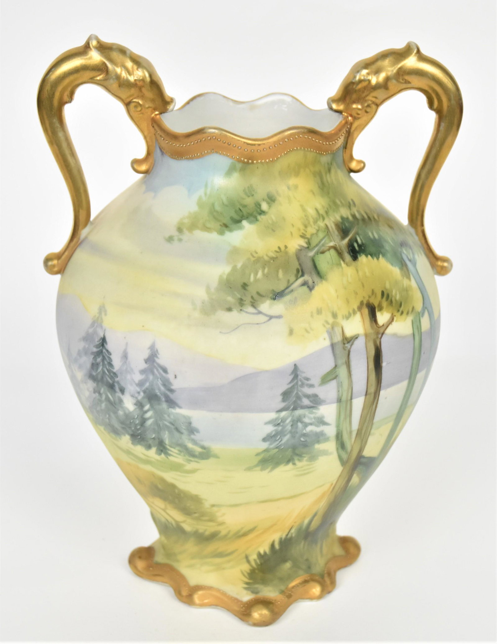 Nippon Wooded Lake Vase: Featuring gold dolphin handles and mold scroll base. 8 3/4" tall, M in wreath logo. Nice continous landscape, Good condition.
