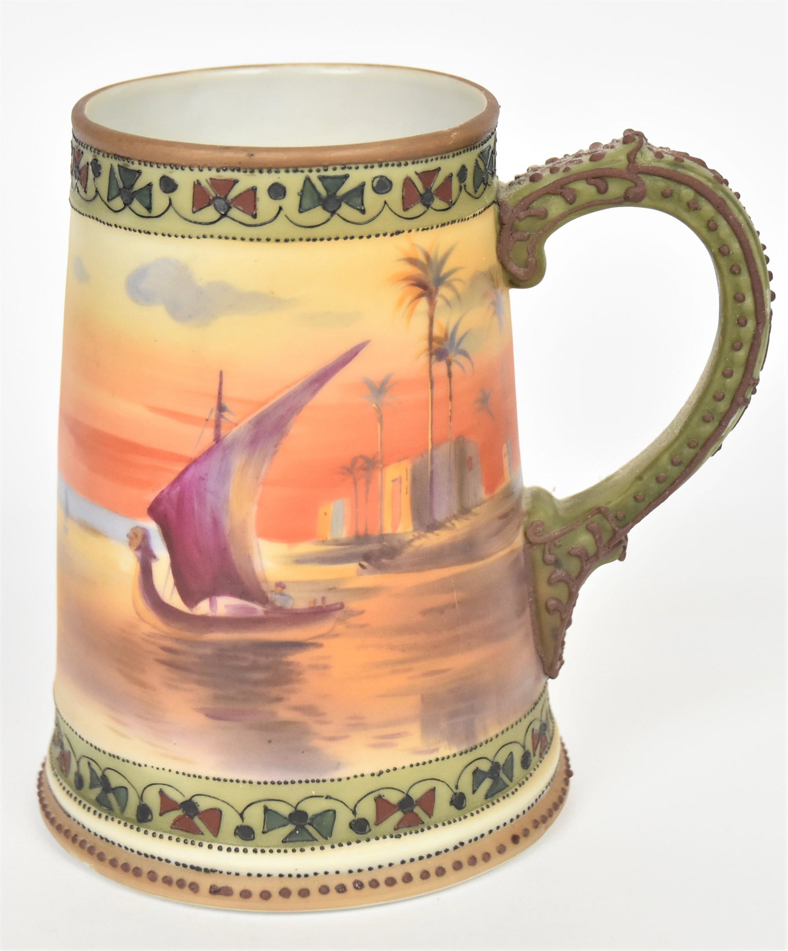 Nippon Cleopatra Barge Moriage Stein: 5 1/2" tall, M in wreath logo Faint message written in the water. Colorful and in good condition.