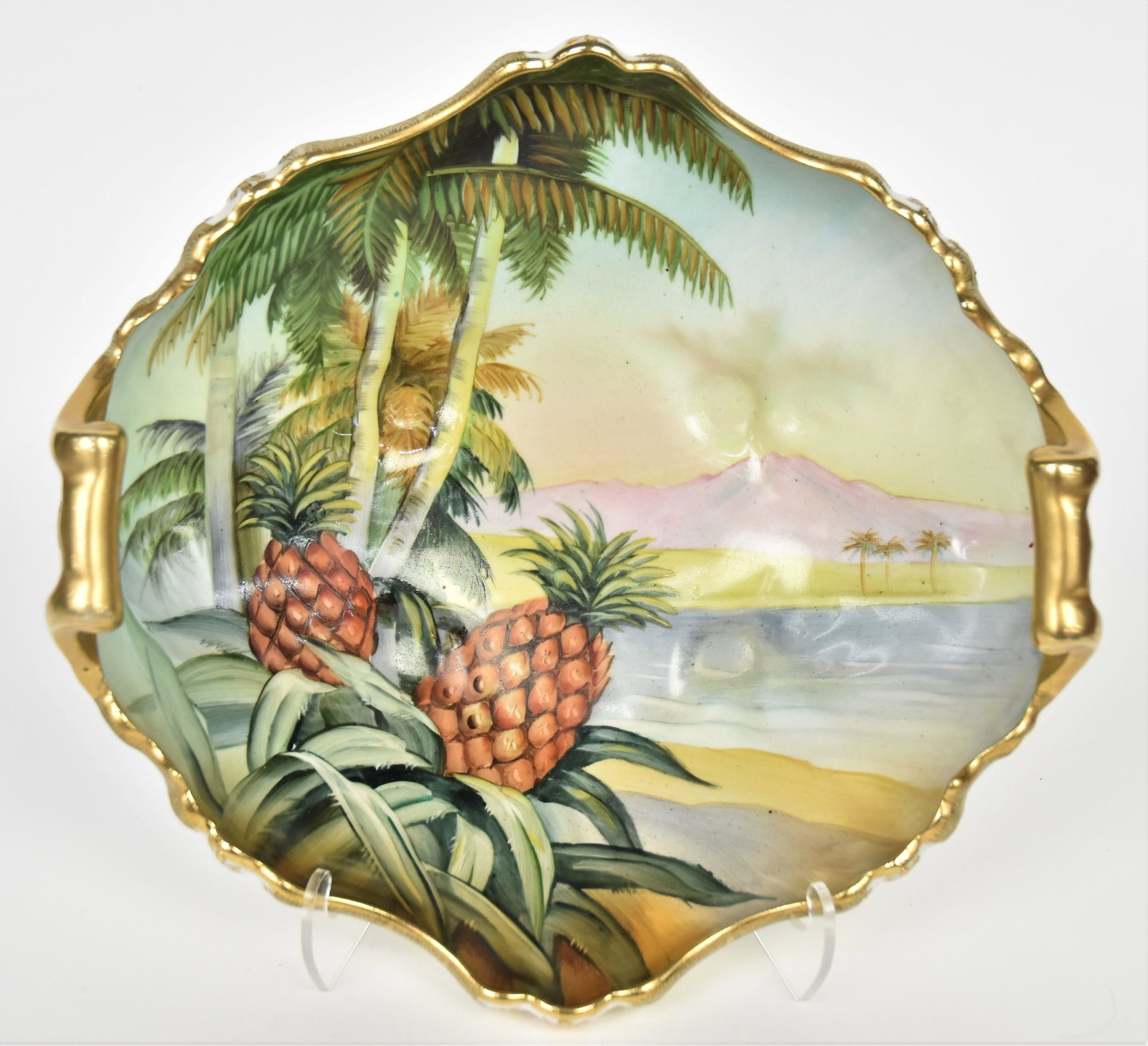 Large Nippon Pineapple and Landscape Bowl: Featuring scalloped rim with raised gold trim. Gold scroll handles and four acanthus leaf feet. 4 5/8" tall to handle top, M in wreath logo. Bold and beautiful, Good condition.