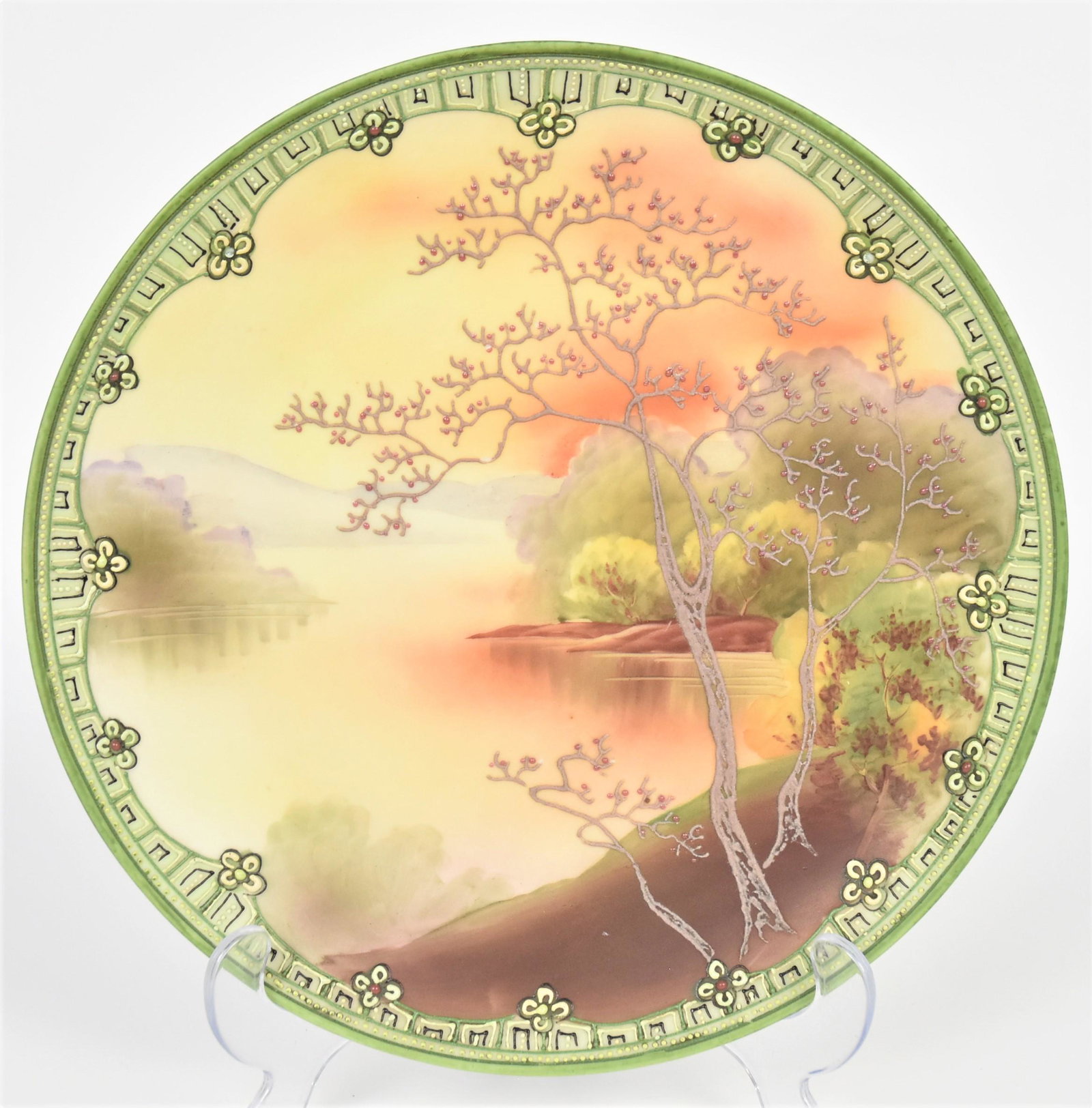 Nippon Moriage Forest and Lake Galle Wall Plaque: Featuring tall trees with berried branches, lakeside at nightfall. Decorative moriage floral border, 10" diameter. Unmarked. Attractive and in good condition.
