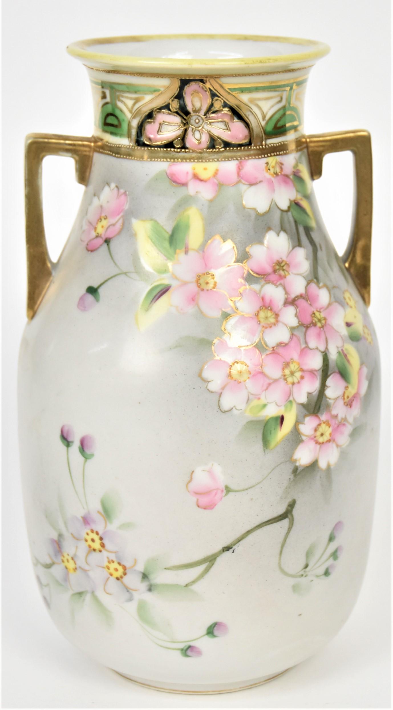 Nippon Apple Blossom Handled Vase: Decorative painted and enameled collar, 8 3/8"tall. Maple leaf logo. Good condition.