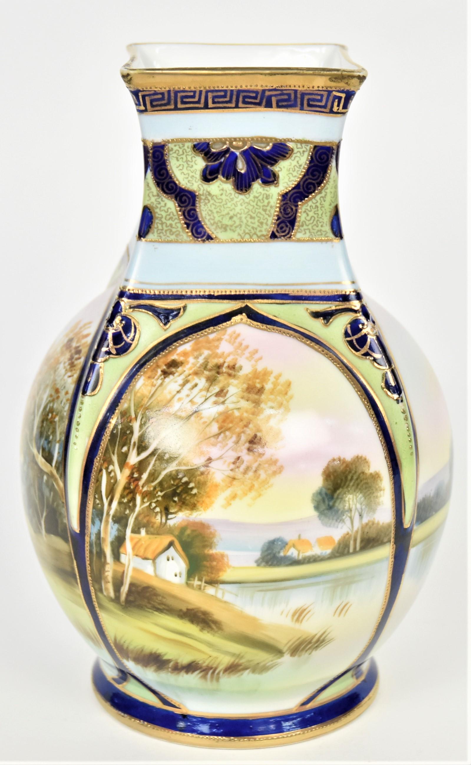 Nippon Scenic Vase: Cobalt enameling and raised gold trim frame, four large ovals decorated with coastal scrapes with cottages, 8 3/4" tall. M in wreath logo. Very good.