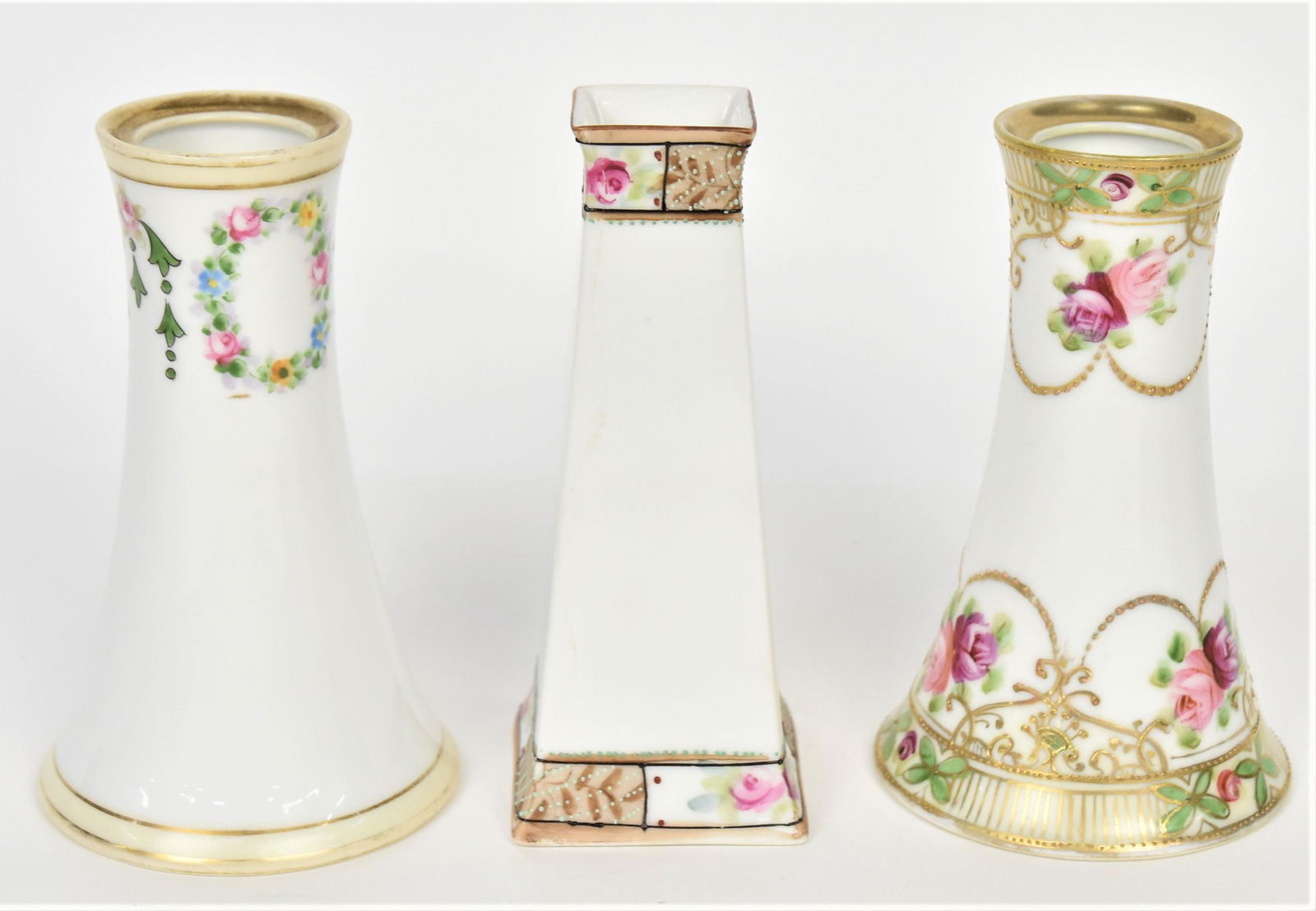Three Nippon Hat Pin Holders: Includes a 4 3/4" with raised gold and baby roses, a 4 3/4" with floral wreaths. Each with M in wreath logo. A 5" squared with baby roses and enameling. Sun ray logo. Hairline extends rim to base.