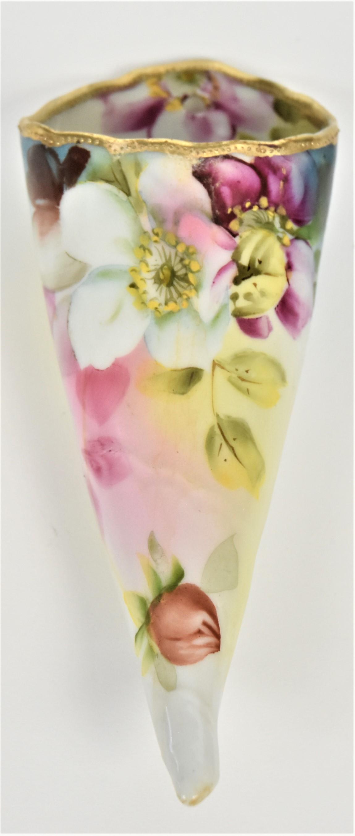 Nippon Horn Wall Pocket: Wild roses decoration and raised gold trim. 7" tall. Maple leaf logo. Interior water deposits. Not often seen item.