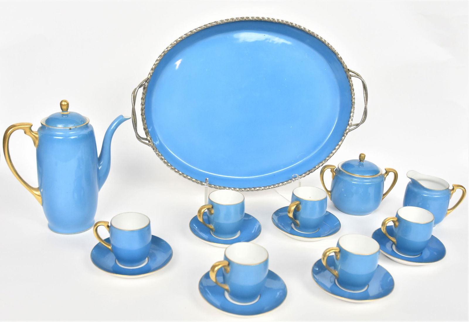 Unusual Noritake Blue Tea Set: Includes 14" tray with coiled silver edge, 7" teapot, six demitasse cups and saucers, and cream and sugar. Finial to teapot repaired, otherwise good condition.