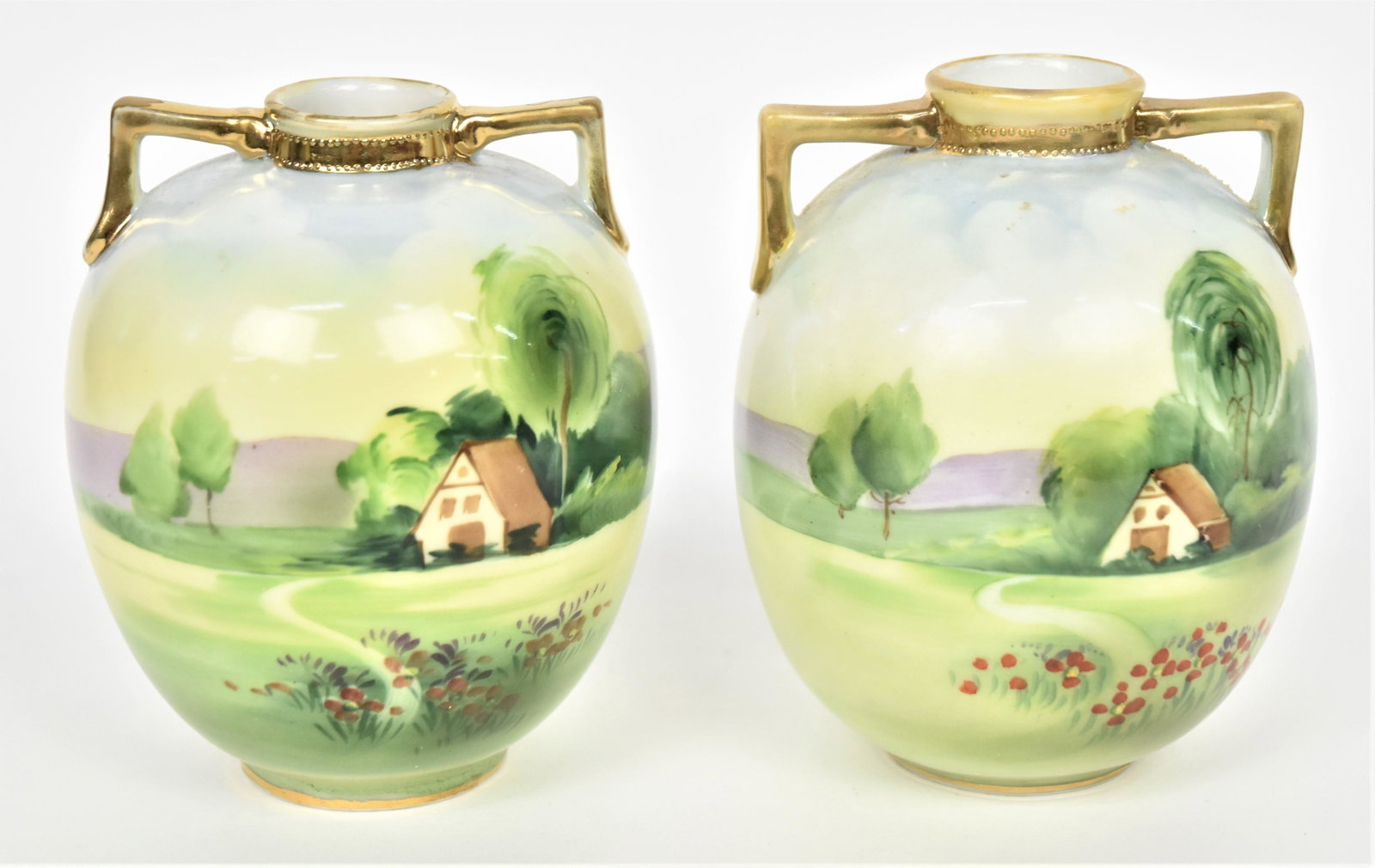 Pair Of Matching Nippon Scenic Vases: Double handled, M in wreath logos, 5" tall. Good condition.