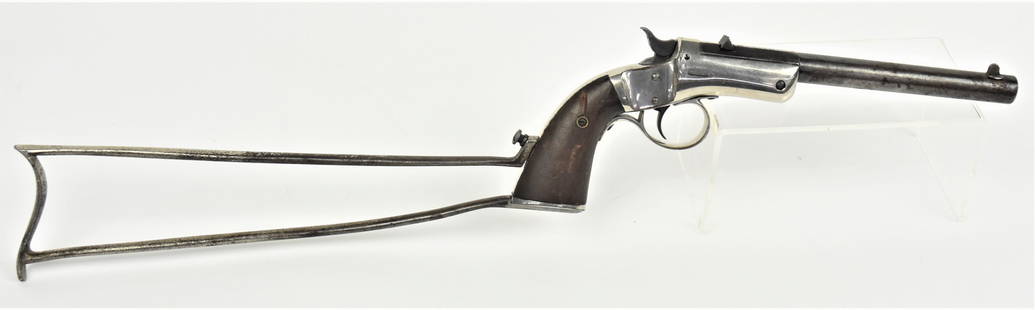 Stevens Tip Up Pistol: .22 caliber 6 3/4" long round to octagonal barrel, marked on top J. Stevens A. & T. Co./Chicopee Falls, Mass. U.S.A., nickel plated frame and two piece walnut grips, with original nickeled steel