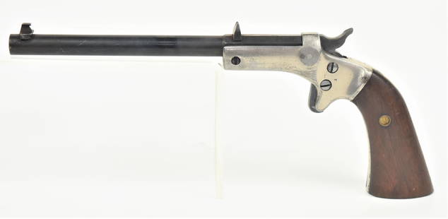 Stevens Tip Up Pistol: .22 caliber with 5 3/8" long round to octagonal barrel marked on left side J. Stevens A. & T. Co./Chicopee Falls, Mass. U.S.A. with nickel plated frame and two piece walnut grips, standing front