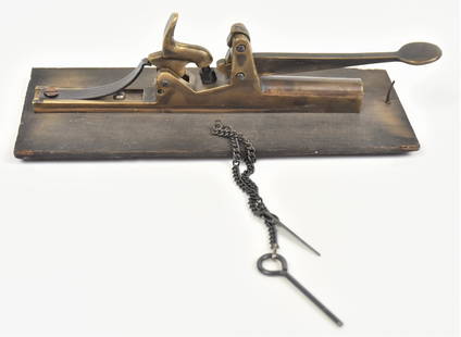 Brass Percussion Trap Gun: Brass circa .32 caliber with 3" long barrel marked on left side Pat. Mar 10, 1862, mounted on poplar board, 8" long. These weapons were used to kill animals, some have suggested they were also used