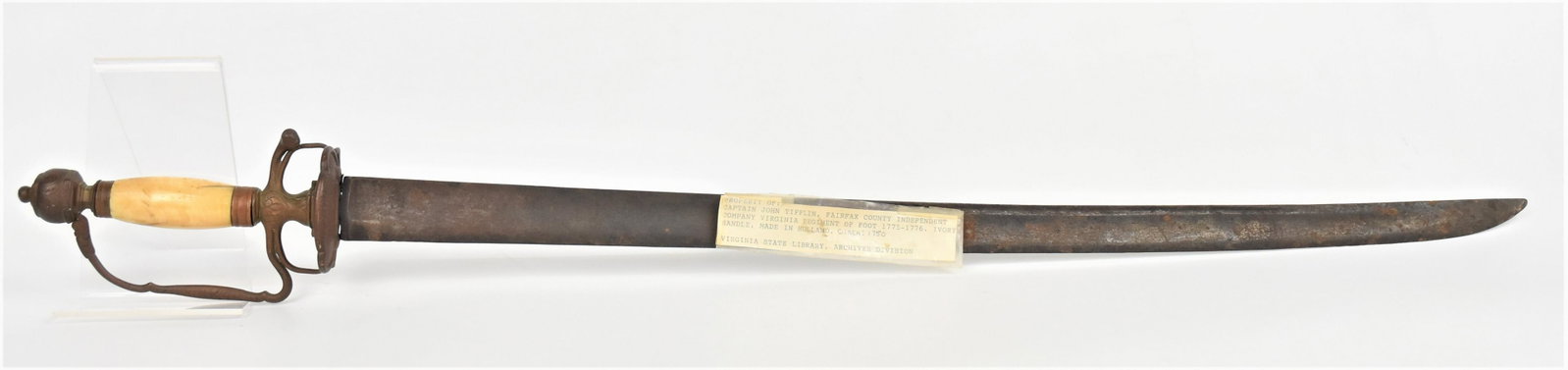 Id'd America Revolutionary War Officers Sword: Steel 26 1/4" long single edged bald with full fuller, engraved brass hilt with guard, knuckle bow and pillow pommel with turned bone grip, total length 33". Typed note attached that reads: Property o