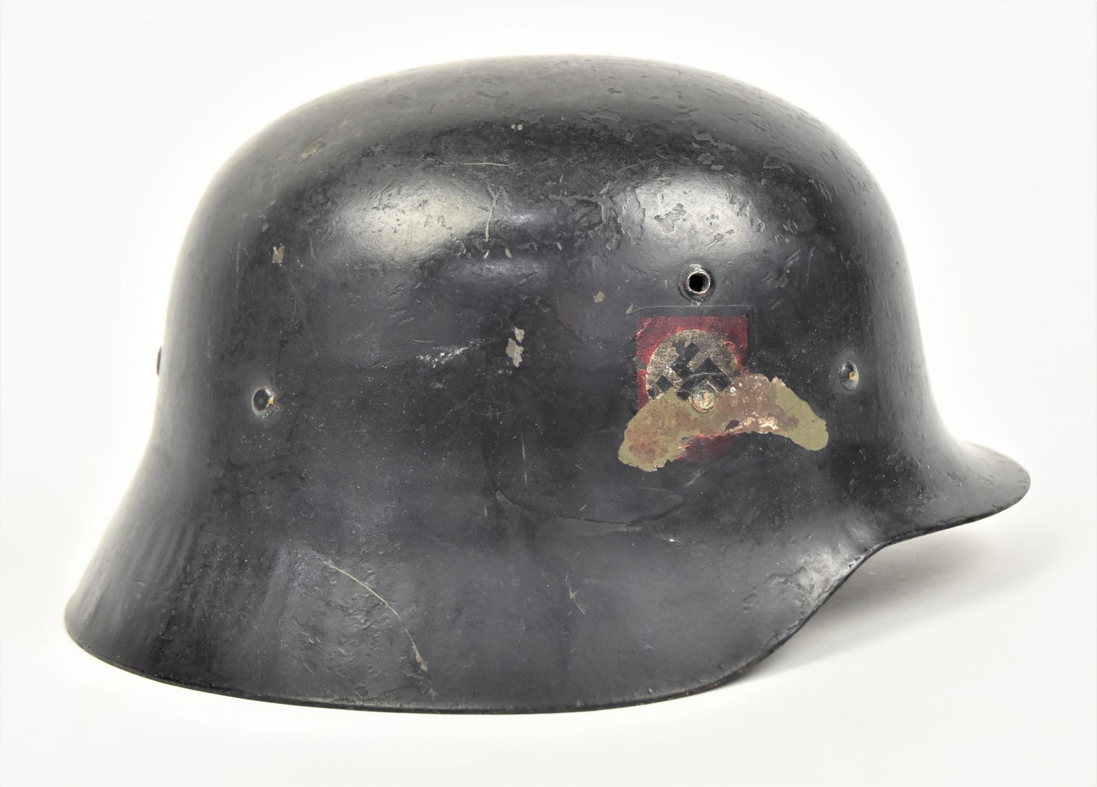 WWII SS helmet: In original black paint, with parts of both decals, Nazis flag is 40% SS symbol is 25%, original leather liner and chin strap, 11 x 9 1/2 x 6 1/2" high. Condition as above & paint circa 87%.