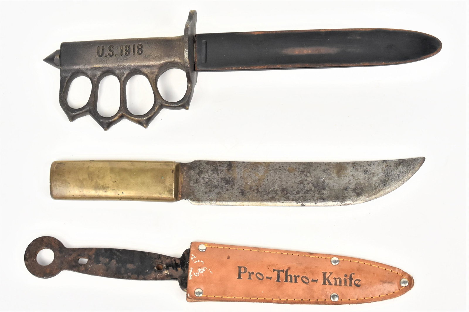 Three Fighting Knives: Including a smith made bowie with brass grip, 11 1/4" long; plus copy of U.S. 1918 Knuckle Trench Knife with cast brass grip and steel scabbard, 12" long; and throwing knife in leather sheath, 11" lon