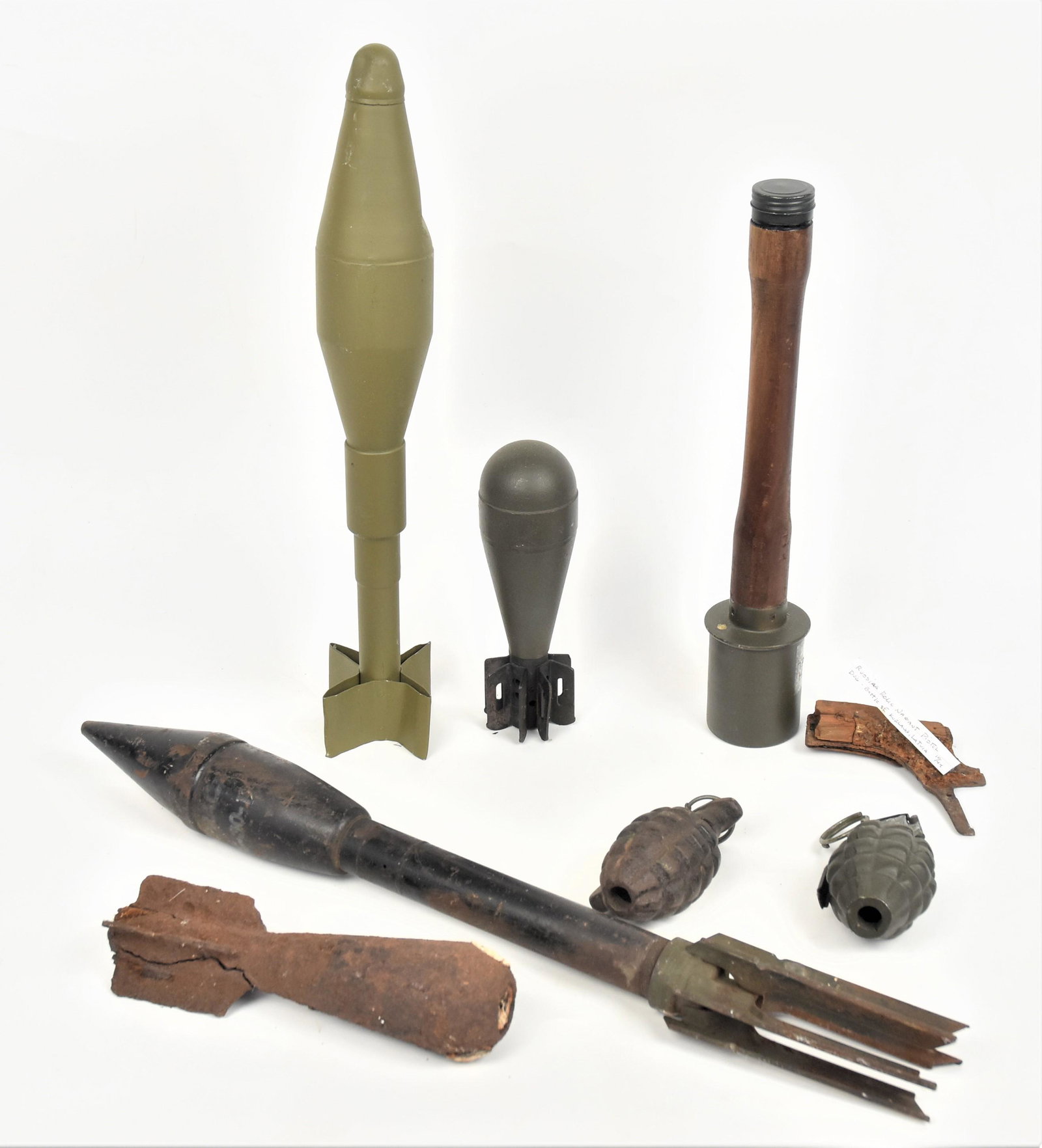 WWII Grenades Plus: Lot of 8, including a deactivated U.S. pineapple type grenade; plus cast iron dummy pineapple grenade; plus reproduction German WWII grenade; plus 30mm mortar round; plus relic mortar round (likely du