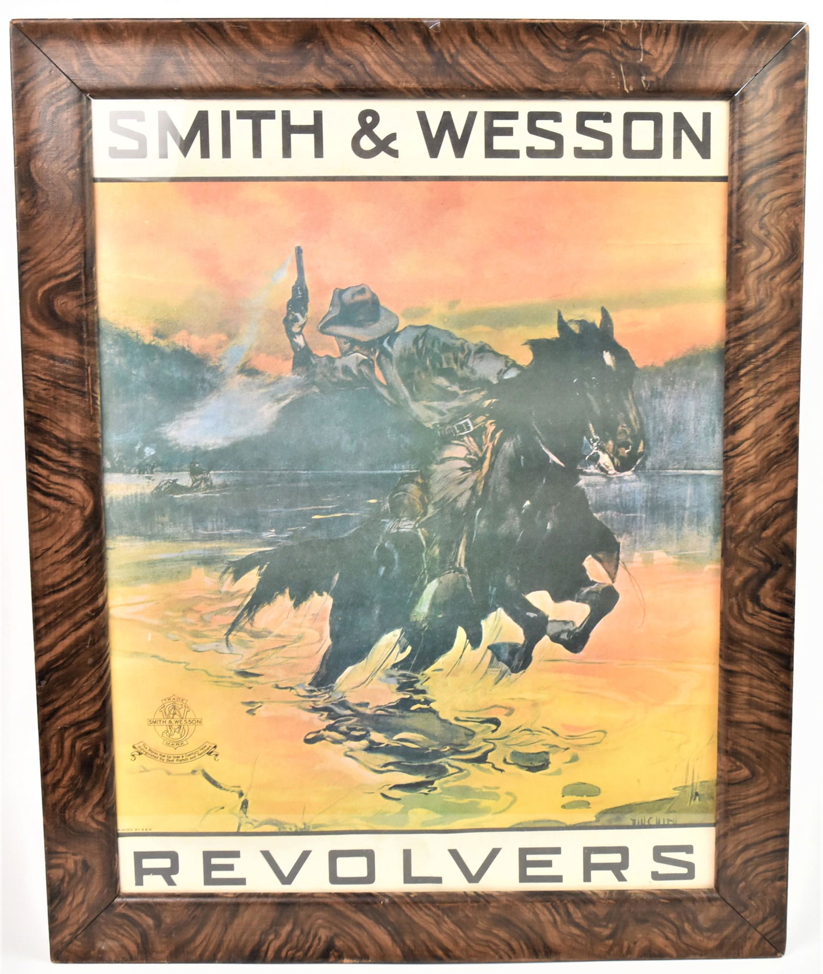 Smith & Wesson Revolver Poster: Chromolithographed with mounted cowboy fleeing from persueing Native Americans, with S&W crest lower left and marked Printed By S. & W. lower left, artist signed in print lower right, 17 x 22", framed
