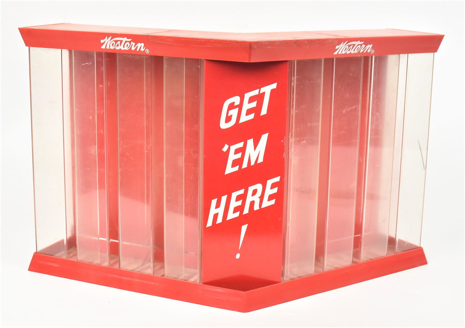 Western Ammo Display Case: Counter top red and clear plastic with white lithographed text reading Western Get Em Here! With four columns for boxes of .22 caliber cartridges on each side, two hinged doors in rear, 17 1/4 x 8 x10