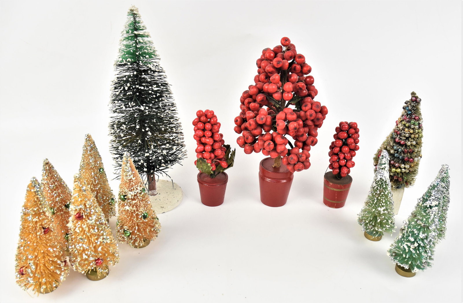 Early Miniature Christmas Trees: Lot of 13, including set of five in gold with red or green bulbs and white glitter, on gold wood stands, 5 1/2" high; plus set of three green with silver bulbs and silver glitter on gold wood stands, 