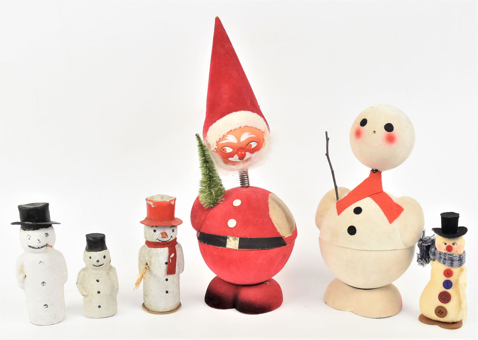 Christmas Candy Containers Plus: Lot of six including two largest snowman and Santa marked Made in West Germany, 10 1/2 & 15" high; plus three card stock decorated snowmen, 4 & 5 1/2" high; and cloth snowman5" high. Condition VG to V