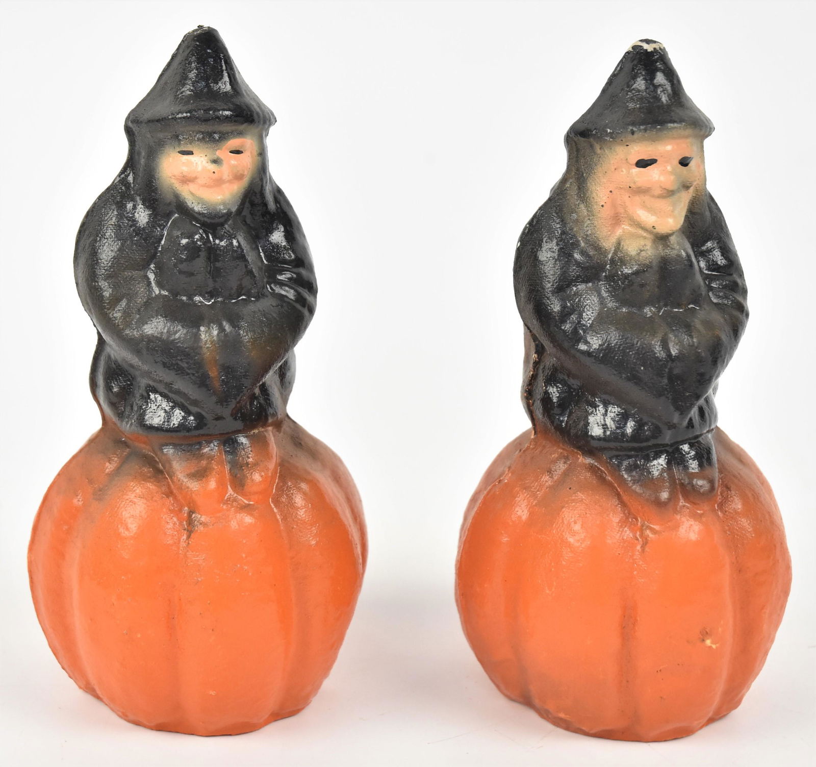 Two Pressed Paper Halloween Decorations: Whitchs seated atop pumpkins in polychrome paint 5 7/8" high. Condition both Fine.