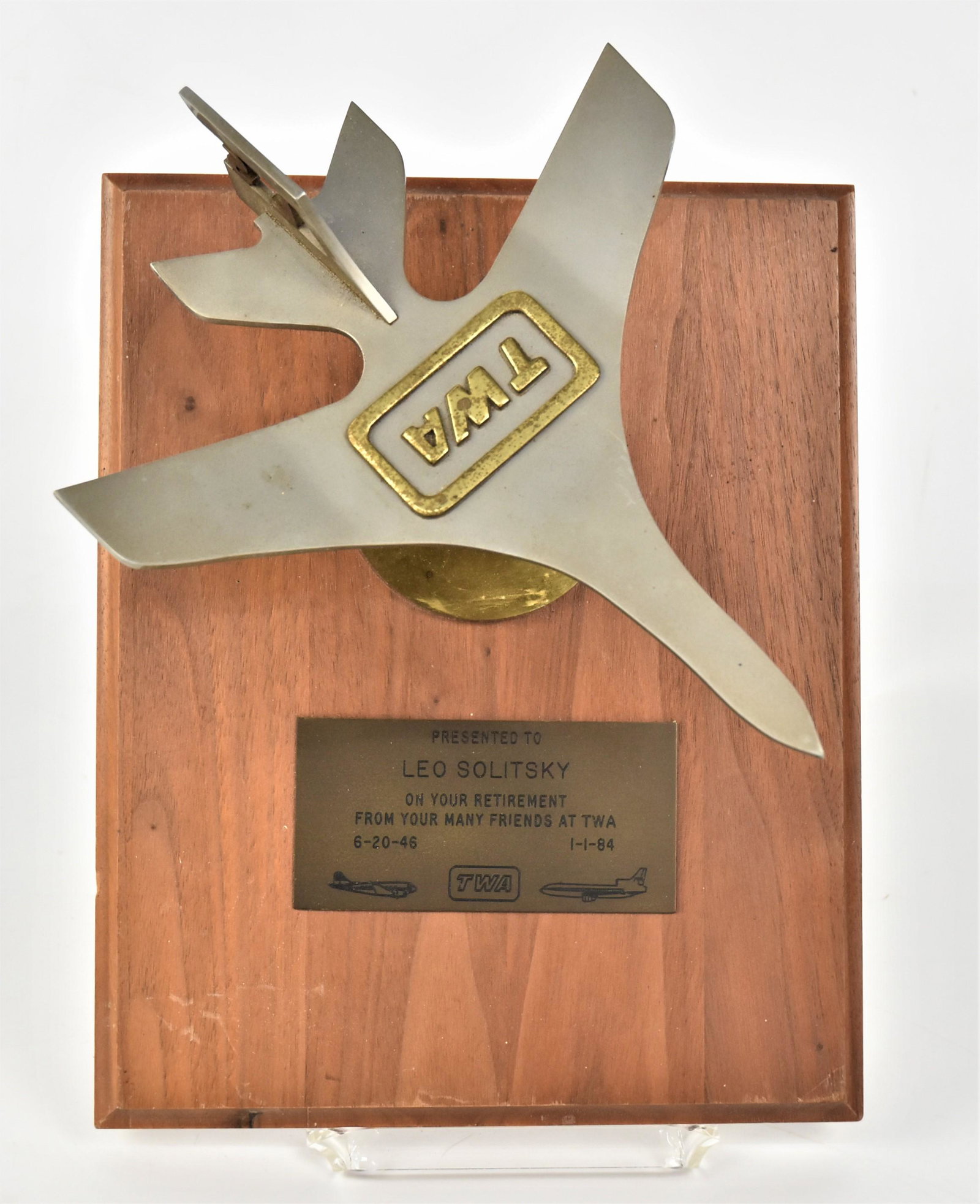 TWA Retirement Sculpture: Brushed steel & brass in the form of a jet sweep wing airliner with brass TWA at top and brass LS on tail, engraved brass plaque reads: Presented To Leo Solitsky On Your Retirement Frm Your Many Frien