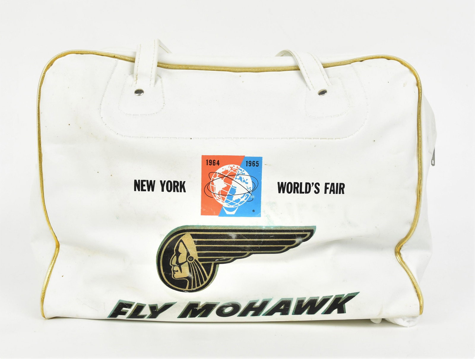 Fly Mohawk Carry On Bag: white plastic with gold trim, each face has Native American profile with stylized feather headress in form of wing and Fly Mohawk below, one side has blue, range, white and black globe with 1964 1965 