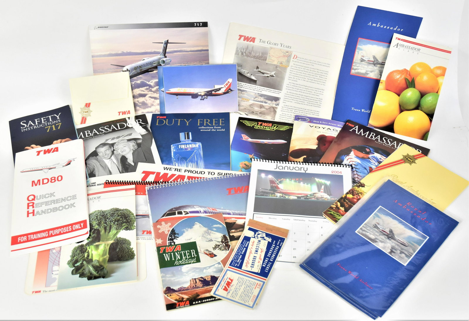 TWA Paper Items: Lot of 39, including two partially printed tickets from 1952, N.Y. to St. Louis & Cairo via Rome to Paris, 7 1/4 x 3 1/4"; plus 1950s illustrated 33pp pamphet entitledTWA Winter holdiays, 5 1/2 x 8" h