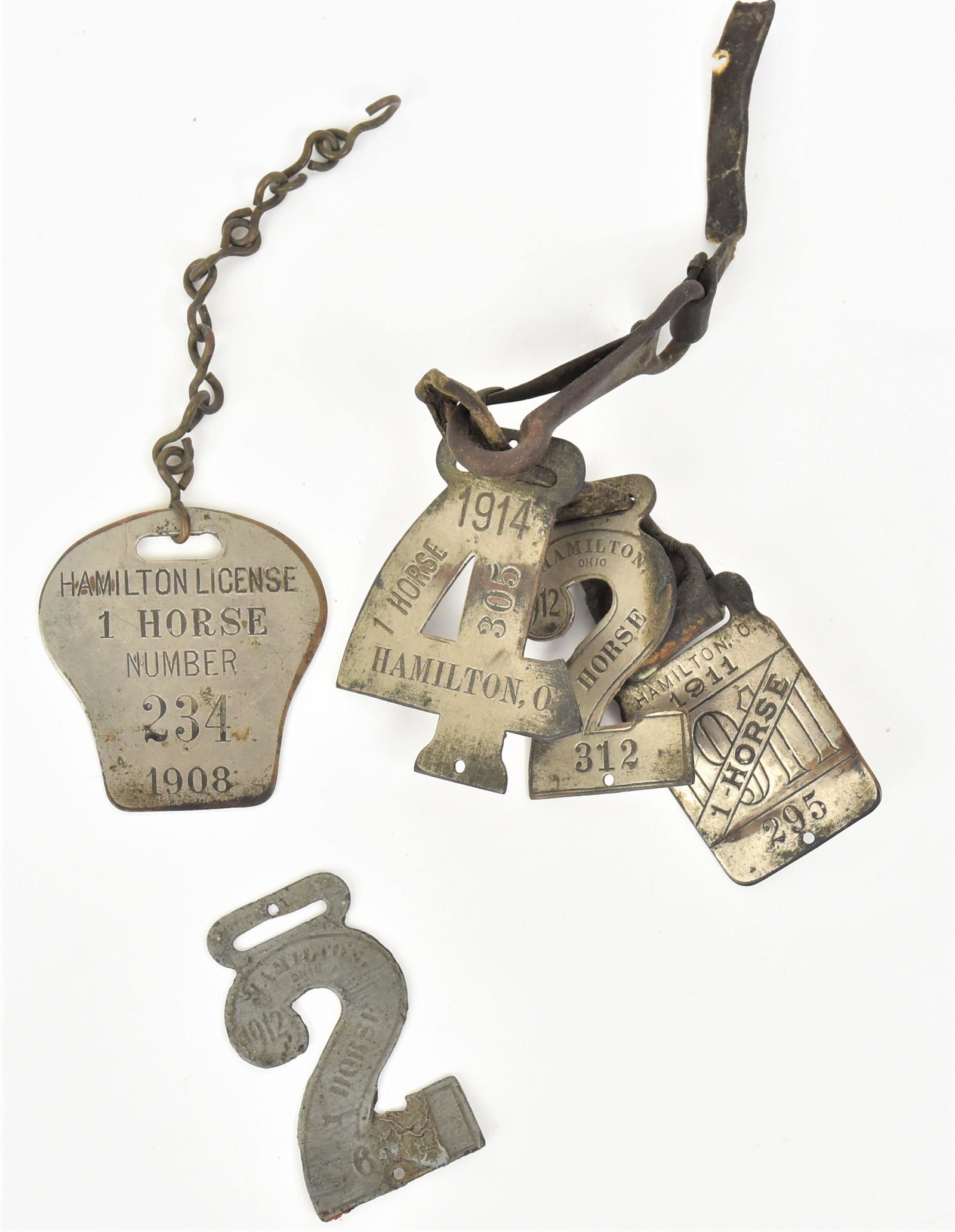 Hamilton Ohio Horse License: Lot of five all nickle plated brass and license for one horse, dates include 1908, 1911, two 1912 in shape of number 2 and one 1914 in shape of number four, 1908 is 2 1/4 x 2 1/2" high. Conditin wer t