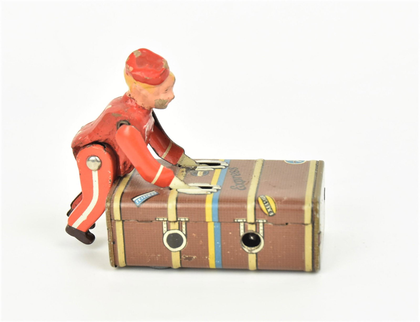 German Express Bellhop Toy: Chromolithographed tin wpring driven, lacking key, marked Gescha D.R. Patent ang. Div. D.R.G.M. Patentd applied for in England, U.S.A., Franc and Japan, 1 3/4 x 3 1/4 x 2 3/4" high. Condition paint cr