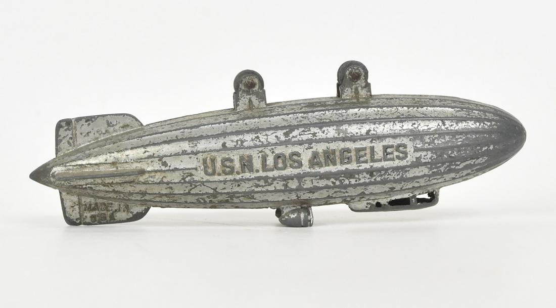 Tootsietoy U.S.N Los Angeles: Zeppline, die cast marked on tail as above and Made In U.S.A., each side with U.S.N. Los Angeles with two wheels, 1 x 5 1/4 x 1 1/2" high. Condition finish worn, still VG.