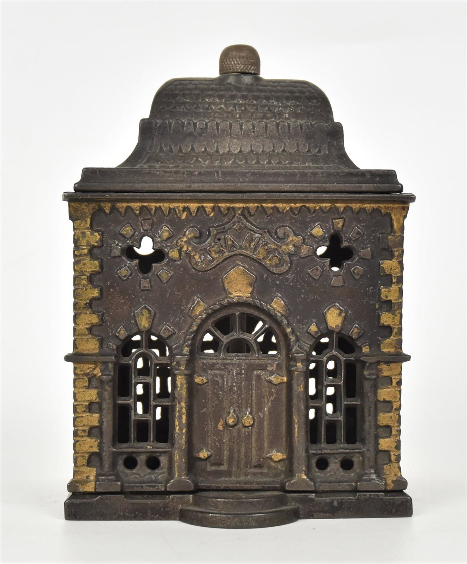 Cast Iron Roof Bank: Still bank book Ref. 1122, by J. & E. Stevens, circa 1887 in original bronze and gold painted finish, 3 x 3 3/4 x 5 1/4" high. Condition paint circa 95%.