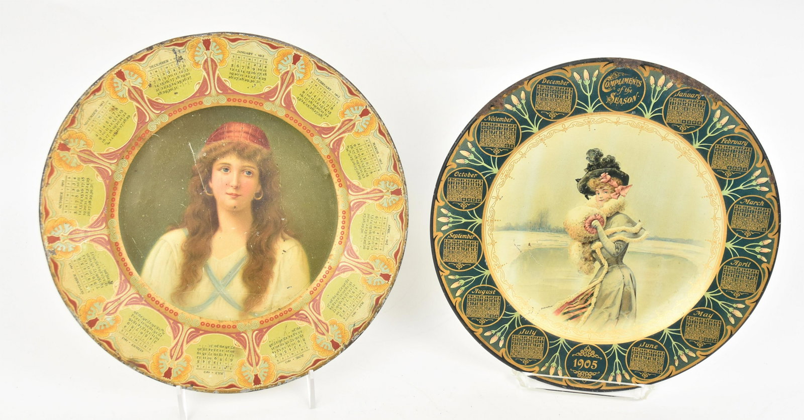 Two Chromolithographed 1905 & 1913 Tin Calendar Plates: Neither with markers names, year 1905 with young lady on frozen lake with fur trimmed dress and muff, 10" diameter; and 1913 with young lady in Roma style dress, 10 1/8" diameter. Condition 1st paint 