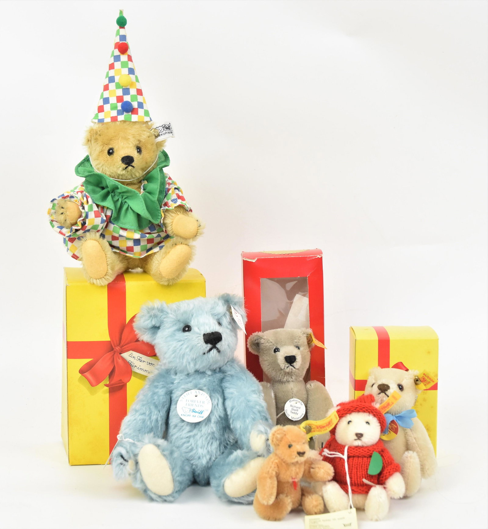 Six Steiff Bears: All from West Germany including three marked boxes, largest is 8" high; smallest is 3" high, all with buttons, printed cloth tags, glass eyes and more. Condition unplayed with VG+ to Fine.