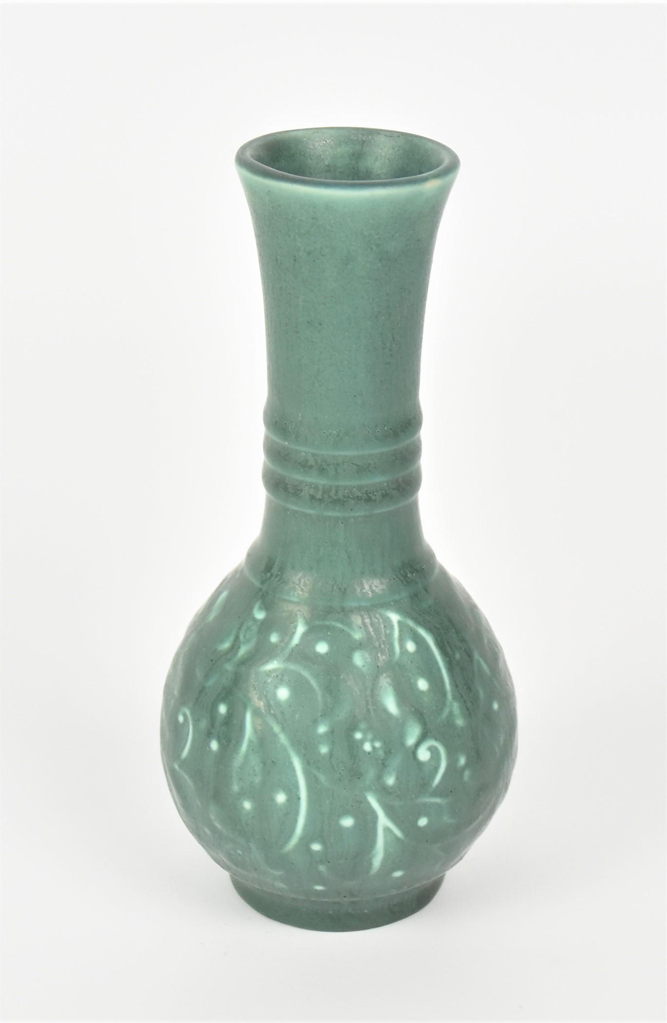 Rookwood Arts & Crafts Vase: In teal green glaze with berries and vine design. Marked with the factory logo, 1933 date, shape 2989, and four impressed dots. Good condition. 6 3/4" H.
