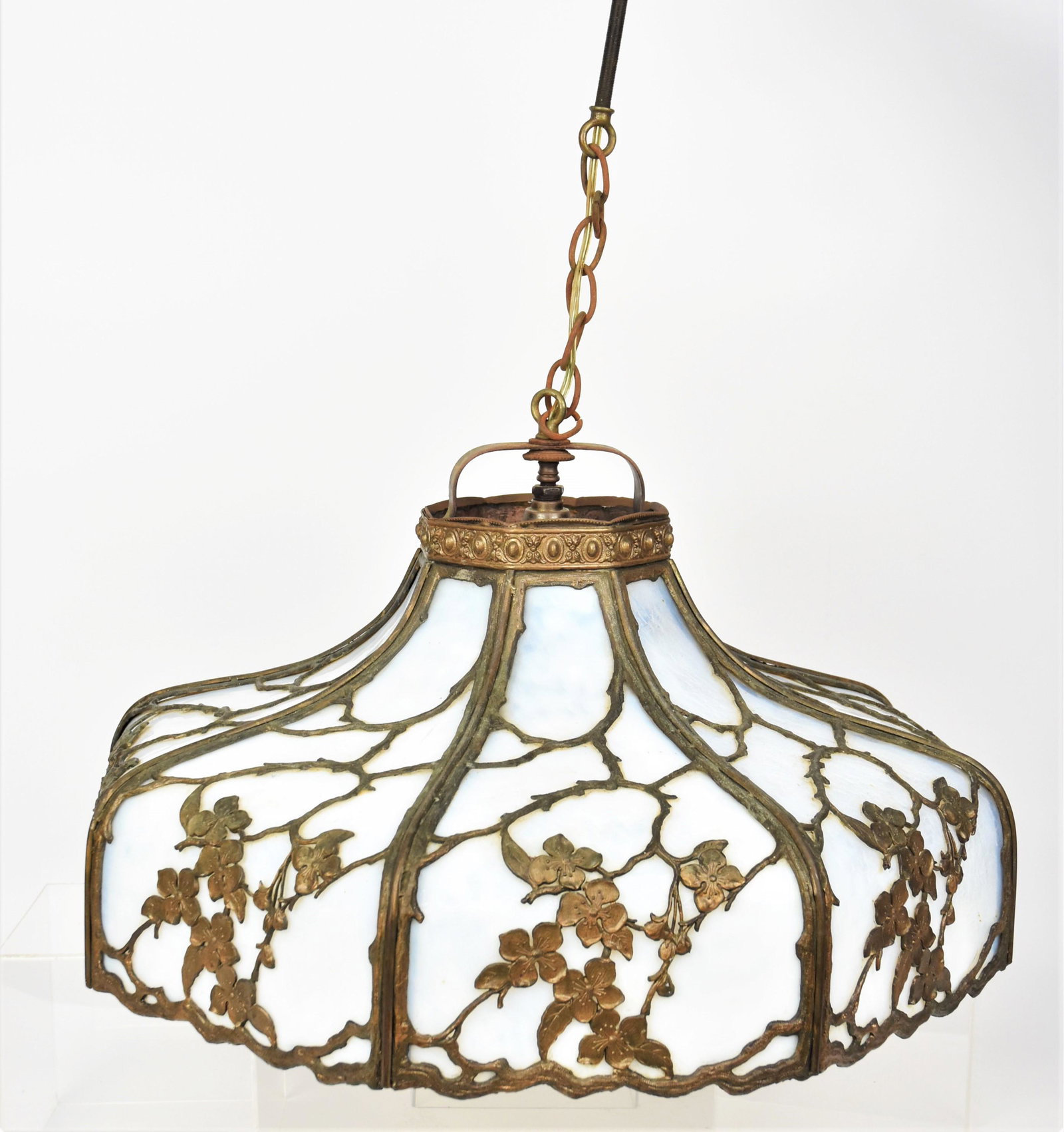 Imposing Art Nouveau Opalescent Curved Glass Chandelier: Featuring eight sides with the meatal work of dogwood blossoms on meandering branches silhouetted against a seldom seen textured glass inserts. Measure 11" to the crown and 23" Diagonally. Equipt with