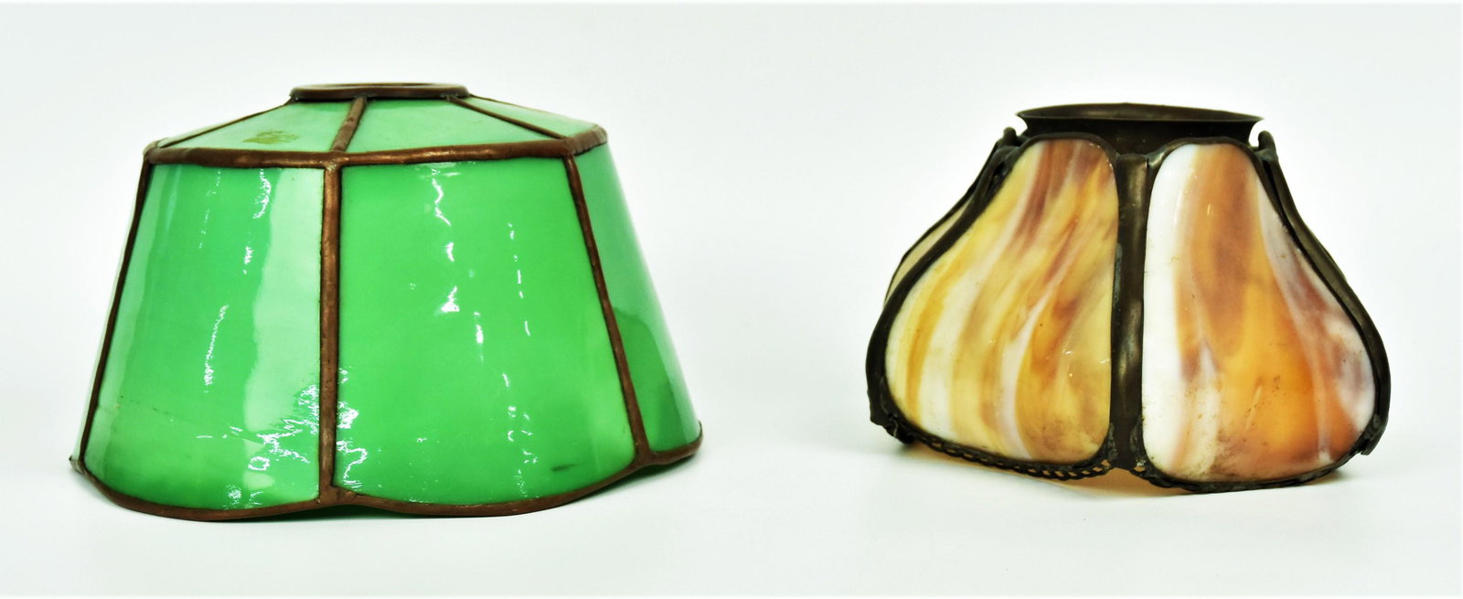 Two Arts and Crafts Slag Glass Shades: 1) 8" shade with green glass & bronze noountings, 2) 6" Slag with six bent caramel slag panels. Both possibly Handel, good condition