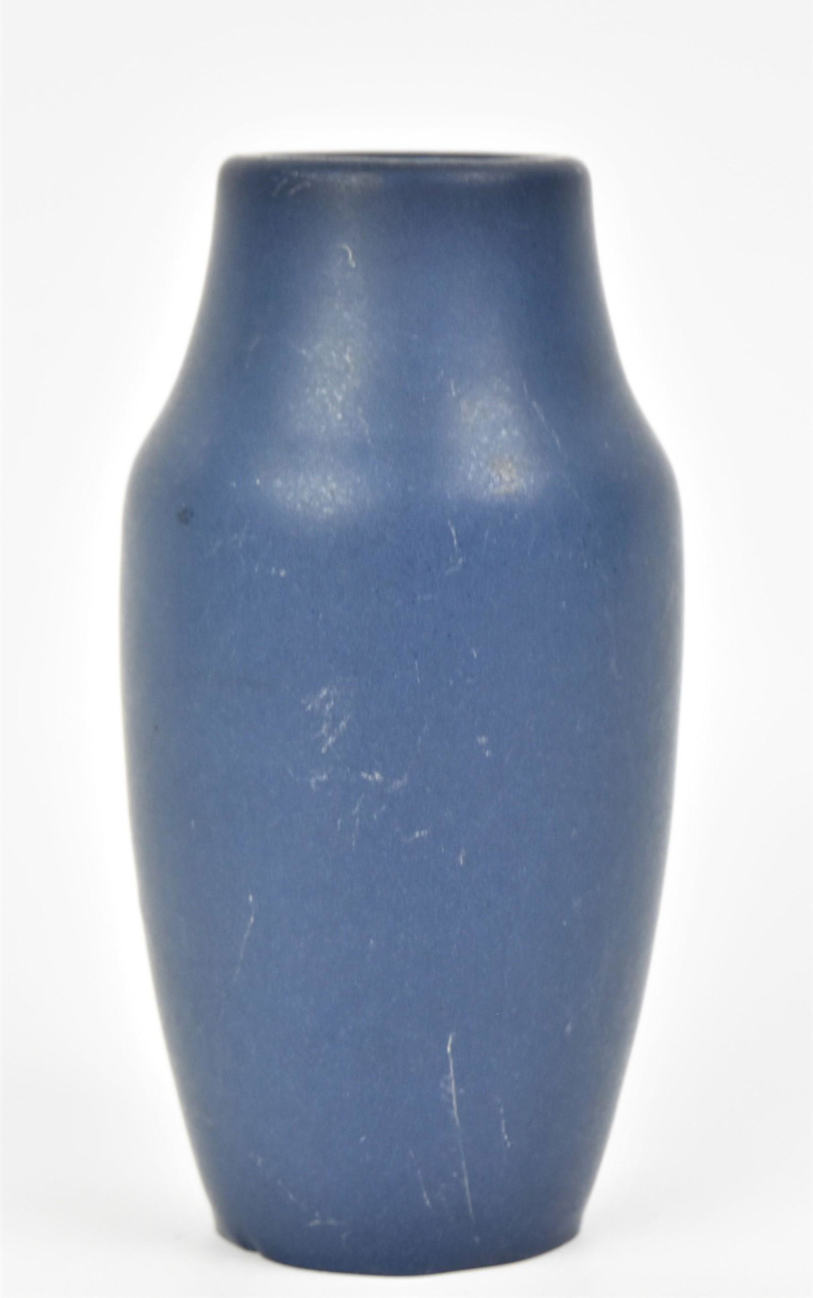 Hampshire Arts & Crafts Vase: Having a matte blue glaze. Marked Hampshire Pottery, 113, and M in a circle. Glaze skip at rim, small outside glaze nick on the base. 6 3/4" H.