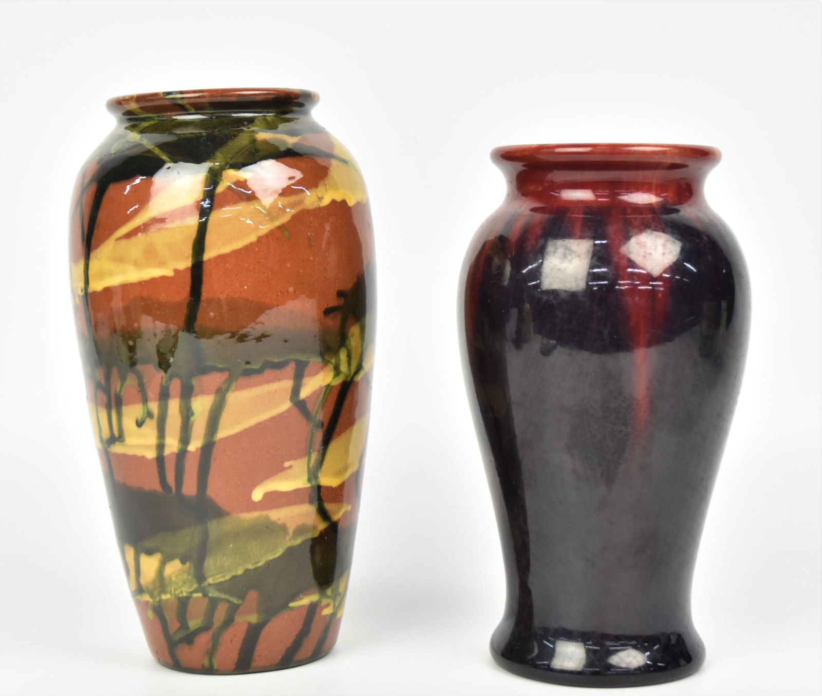 Two Arts and Crafts Pottery Vases: 9" Peters & Reed marbelized, unmarked and 8" Michael Anderson & Sons Denmark in cobalt over ruby glazes, Impressed MA& S, Danmark, 149. Each in good condition.