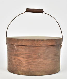 Bentwood Pantry Box: Natural finish hickory and spruce with lid with bent wood band, wire swing bale handle with turned maple grip, nice old patina, 11 1/4 diameter x 6 3/4" high. Condition Fine.