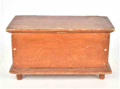 Miniature Decorated Blanket Chest: Circa 1830-50 in white pine, likely New England with six board construction with hinged overhanging lid, swirled grain painting in red over yellow with turned legs, 11 x 5 1/2 x 6 1/8" high.