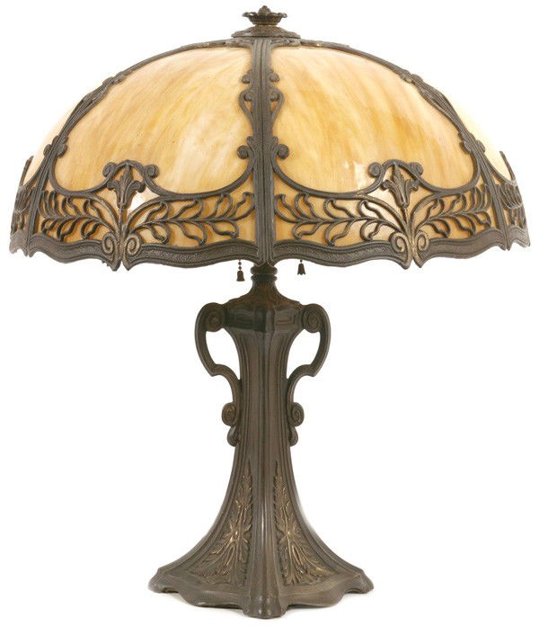 MILLER SLAG GLASS OVERLAY TABLE LAMP: Six curved caramel slag panels with floral metal overlay. Original base. Still retains some original paint to metal. Excellent condition. 18 1/2" shade. 21 1/2" high.