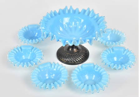 Seven Piece Blue Art Glass Fruit Set: Consisting of a cased glass serving bowl on standard impressed WMW base 5 1/2"H x 8"W And six matching bowls 1/2" H x 4 1/2" W, attractive. Good condition..