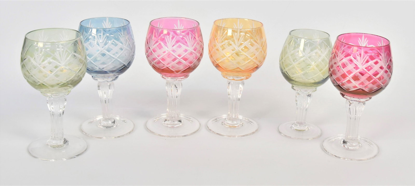 Six Bohemian Multi-colored Cordials: With wheel cut cross-hatch designs clear reeded stems. 4 1/2" H. All in very good condition.