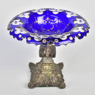 Bohemian Cobalt Blue Compote: Cobalt blue cut to clear compote with worn gold trim fastened nto a ornate metal standard. 7" H x 8 1/4" Dia. Repair to stem but otherwise good condition