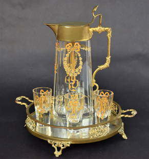 Bohemian Liquor Decanter: Decanter, 8" high with three 2 1/2" high cordials, clear cut panels with enamel decorations. On fancy mirrored tray 2"high x 7" diameter. Discoloring to mirror but otherwise good condition. Nice set.