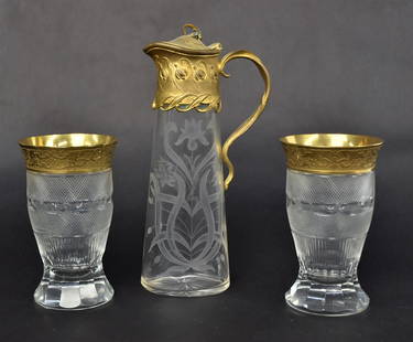 Bohemian Decanter & Tumblers: Art nouveau liquor decanter with fancy hinged cover & handle, 8" high. Wheel engraved floral pair Moser 4 3/4" H tumblerswith gold cameo rims, Venetian cross hatch, thumbprint & cut panels. Good