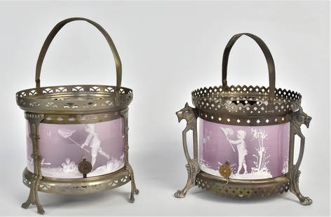Two Mary Gregory Warmers: Each with lilac glass inserts decorated with boys catching butterflies. 7" and 8" in height with handles up, 5" W, not often seen in Lilac color. Some wear to silverplate on one, both have a few very