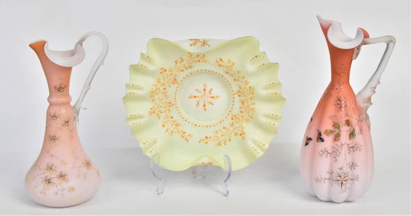 Victorian Art Glass Ewers, Plus: Two Apricot stain ewers, each beautifully enamel decorated. Both have frosted branch handles , 10 1/4"H and 9" H, Plus pale green ruffled bowl with delicate enameling 2 1/4"H x 9" Dia, all velvet