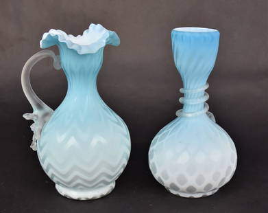 Two Blue Mother of Pearl Vases: A 7 1/4" harringbone ewer with camphor handle. A 7" diamond quilted vase with a frosted serpentine trim. Both good condition.