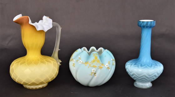 Victorian Art Glass Ewers, Plus: Two are mother of pearl, a 6 3/4" seldom seen yellow ewer with camphor handle, a 6" blue harringbone vase, a 3 1/2" blue ribbed rose bowl with enameling. Condition all VG.