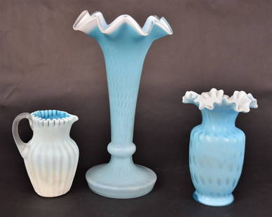 Three Blue Satin Glass Items: A 9' diamond quilted vase, a 5 1/4" raindrop mother of pearl vase and a 4 1/4" ribbed cased creamer with camphor handle. Very good condition to all.